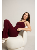 Maroon leggings on a woman on a white background

