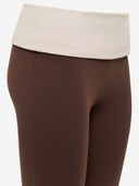 Brown flared pants with a white waistband on a white background

